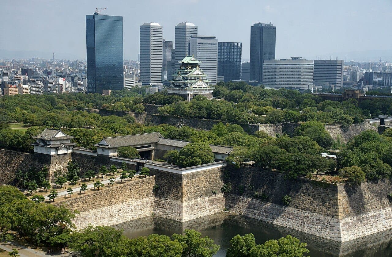 Osaka Castle with cherry blossoms in the foreground, symbolizing historical charm