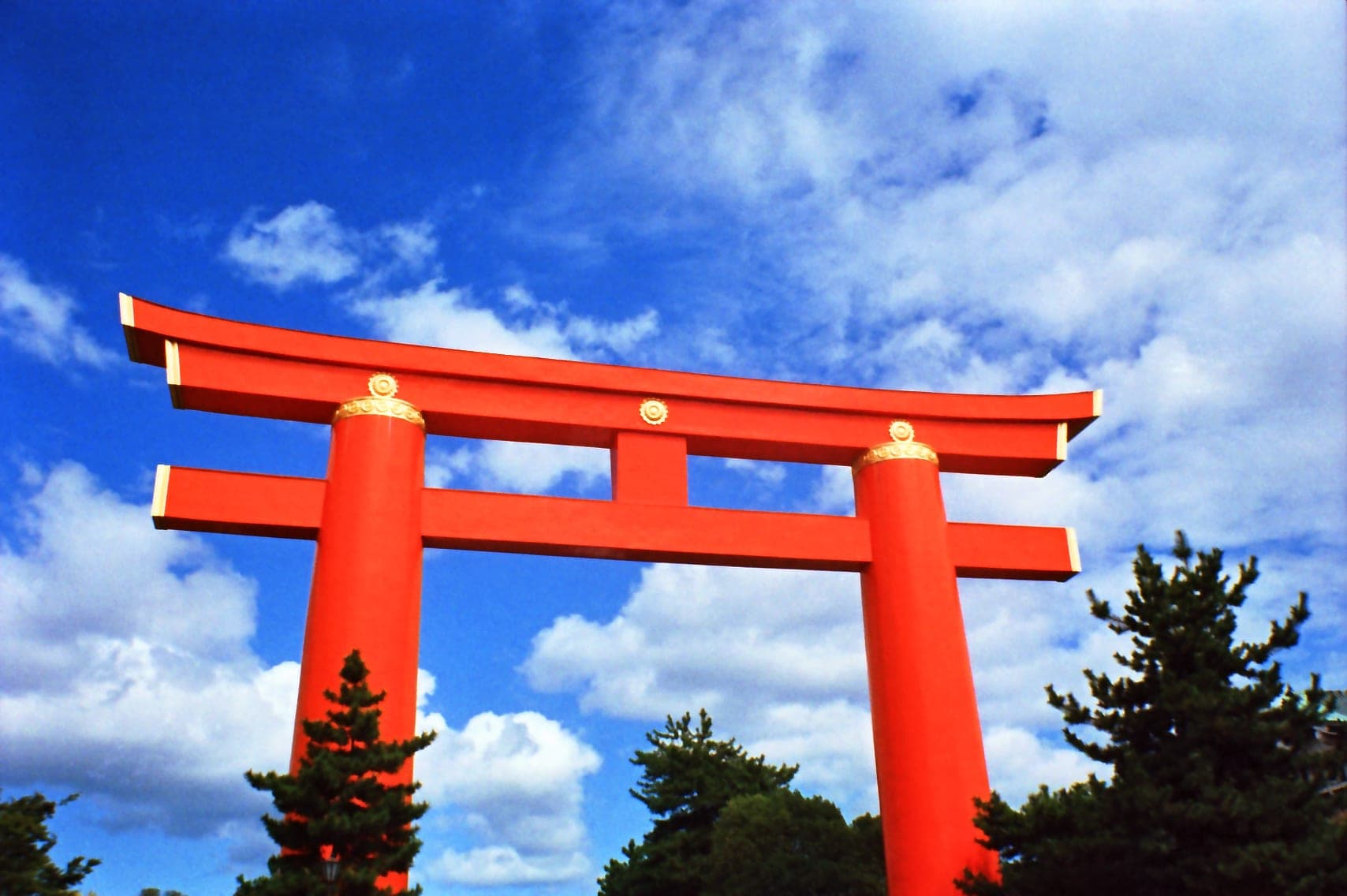 Vermilion torii gate at Heian-jingu shrine in Kyoto against a blue sky