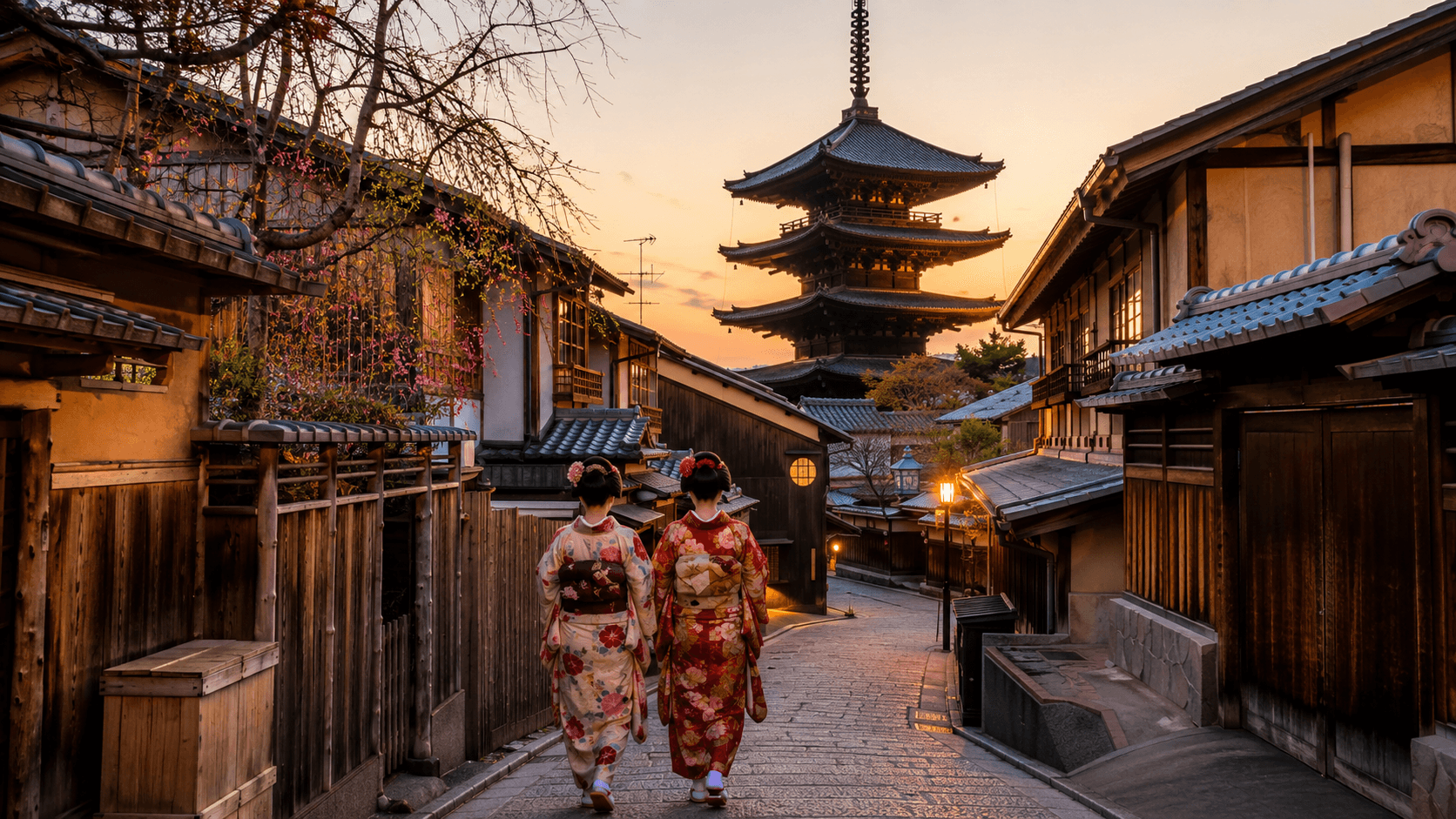 Historic street in Kyoto with traditional wooden machiya townhouses and a five story pagoda at sunset