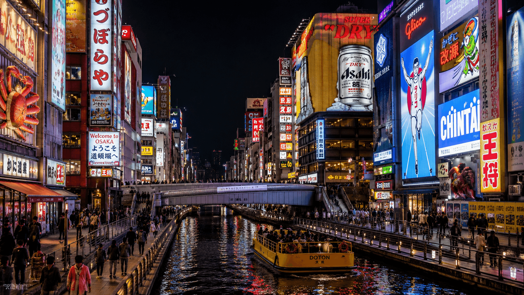 Dotonbori canal district in Osaka at night with glowing neon signs reflecting on the water