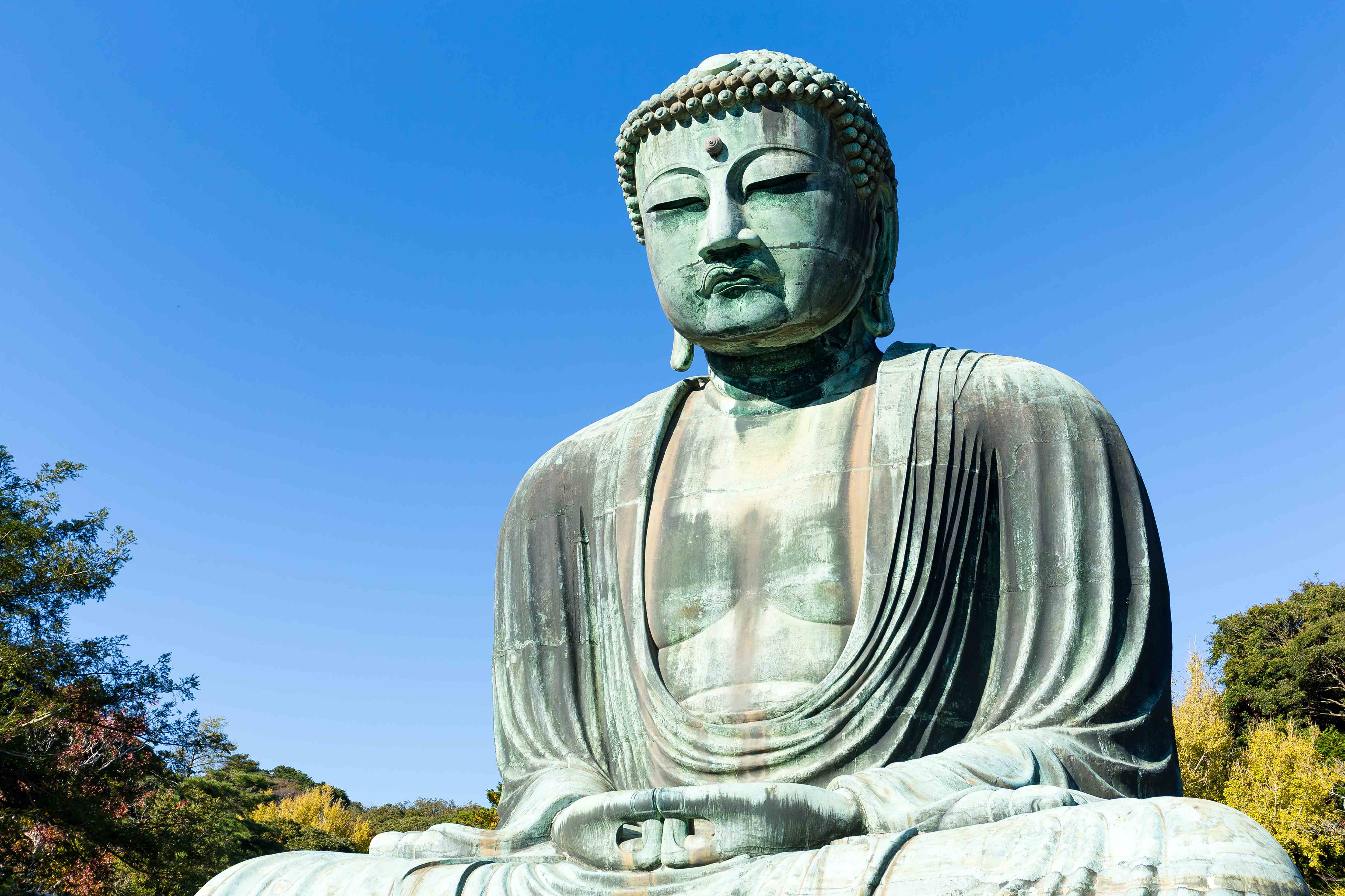 Great Buddha statue under clear blue sky in Kamakura Japan